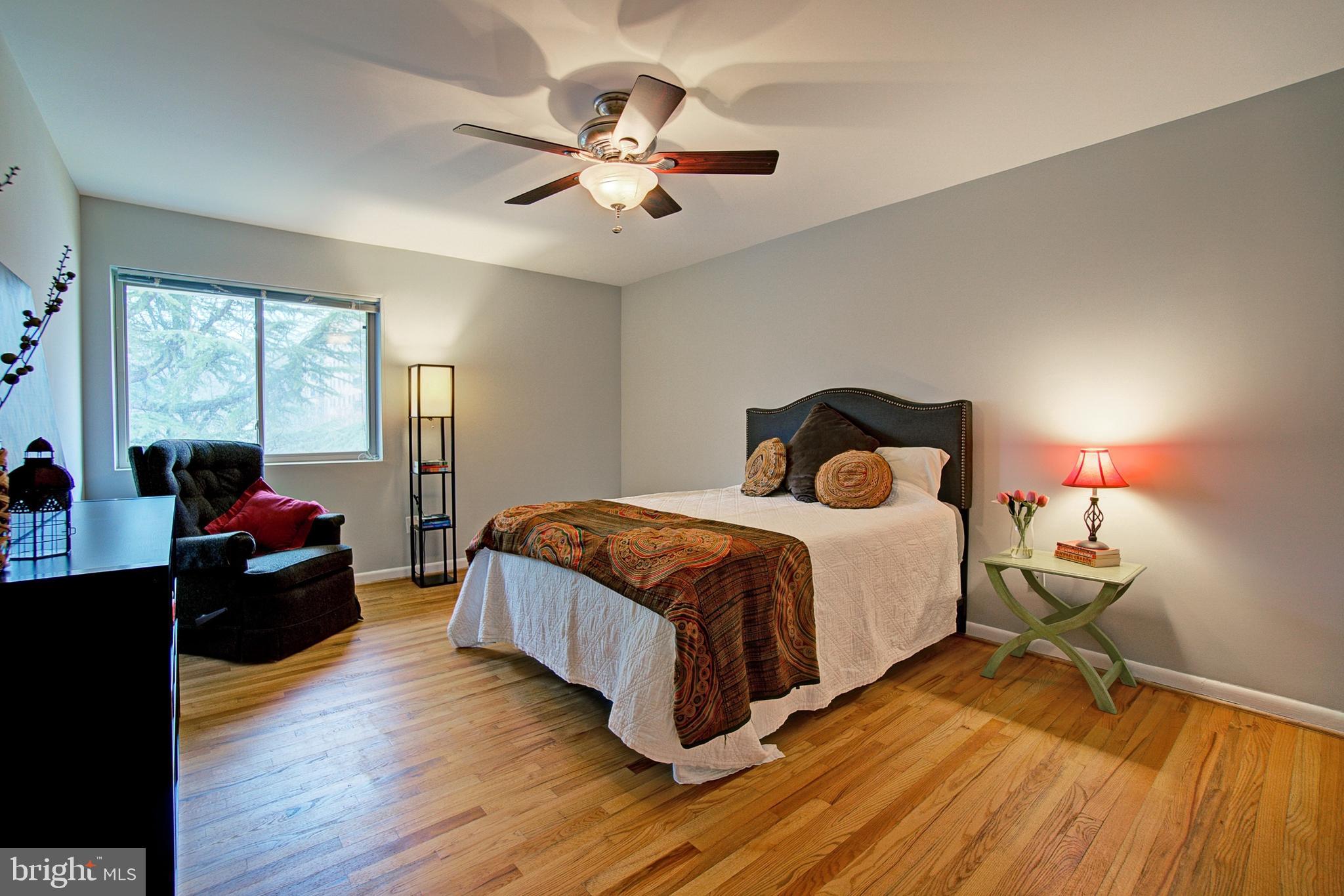 8706 Manchester Road, Unit 5 Silver Spring, MD 20901 - Photo 14 of 25 a bedroom with a bed and wooden floor