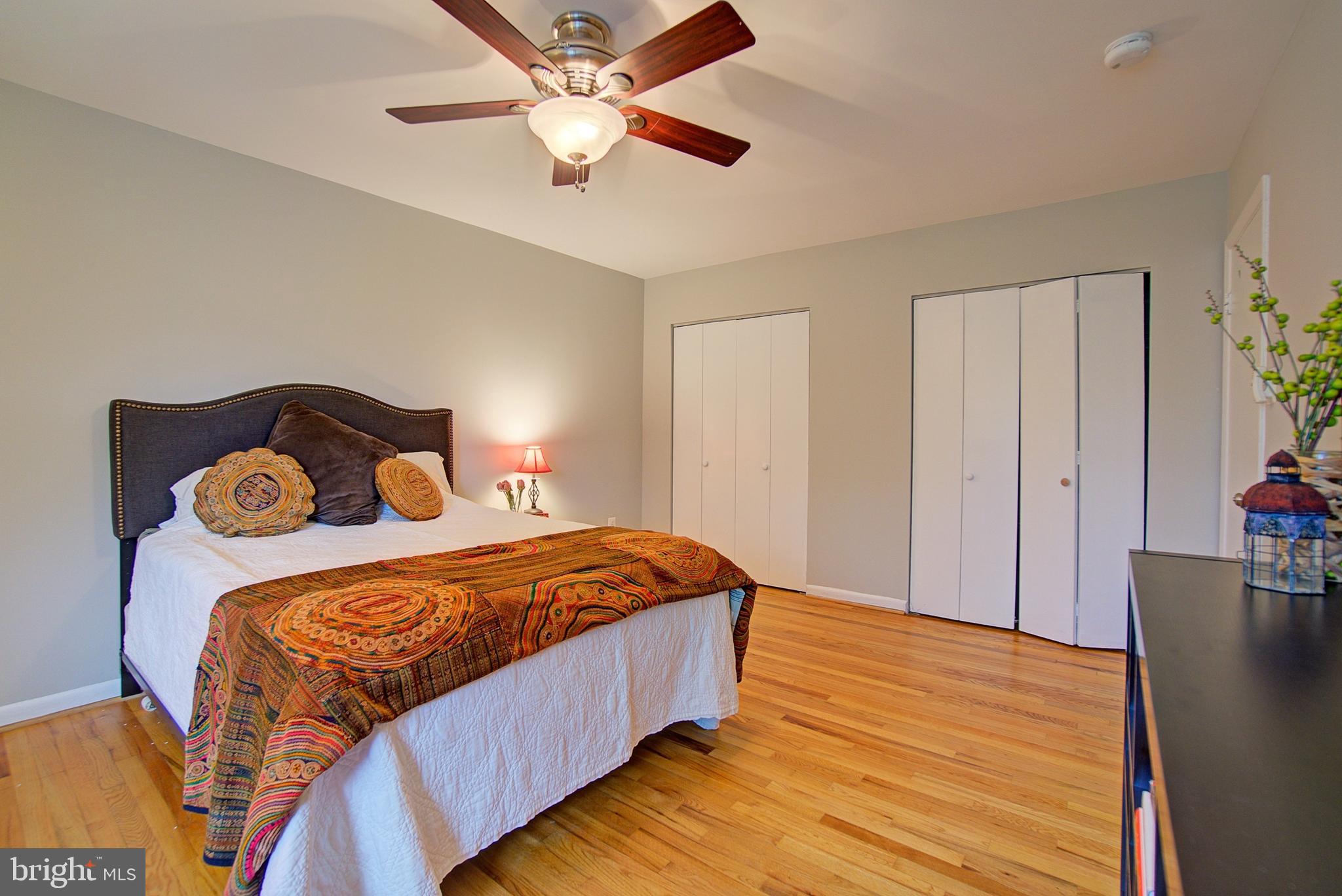 8706 Manchester Road, Unit 5 Silver Spring, MD 20901 - Photo 15 of 25 a bedroom with a bed and a chandelier