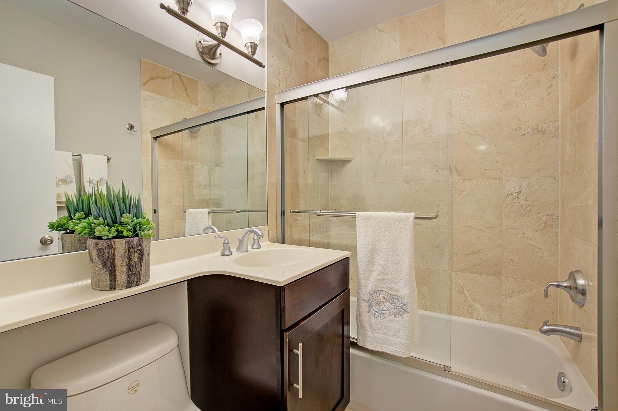 8706 Manchester Road, Unit 5 Silver Spring, MD 20901 - Photo 16 of 25 a bathroom with a sink a mirror and a shower