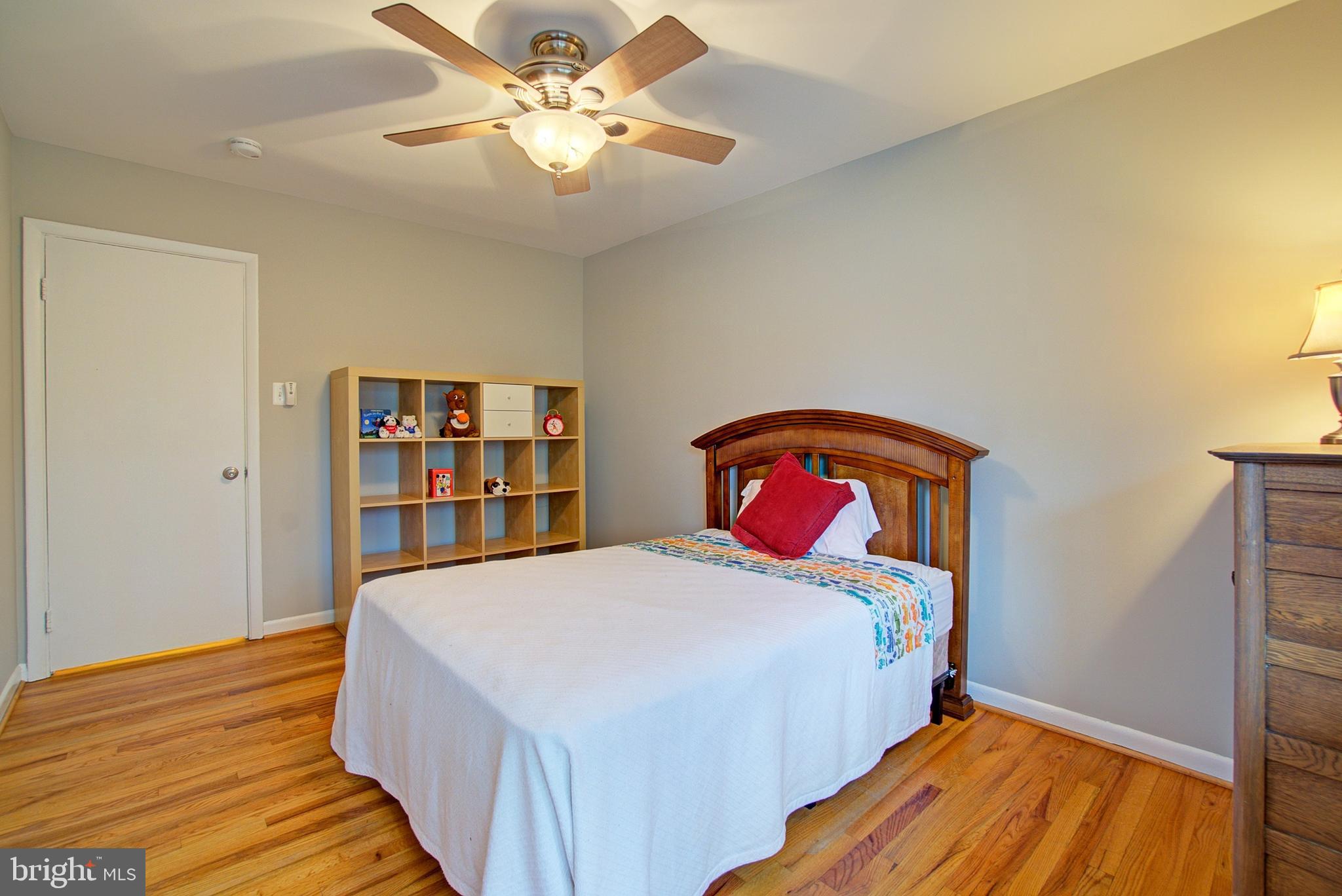 8706 Manchester Road, Unit 5 Silver Spring, MD 20901 - Photo 18 of 25 a bedroom with a bed and a bookshelf