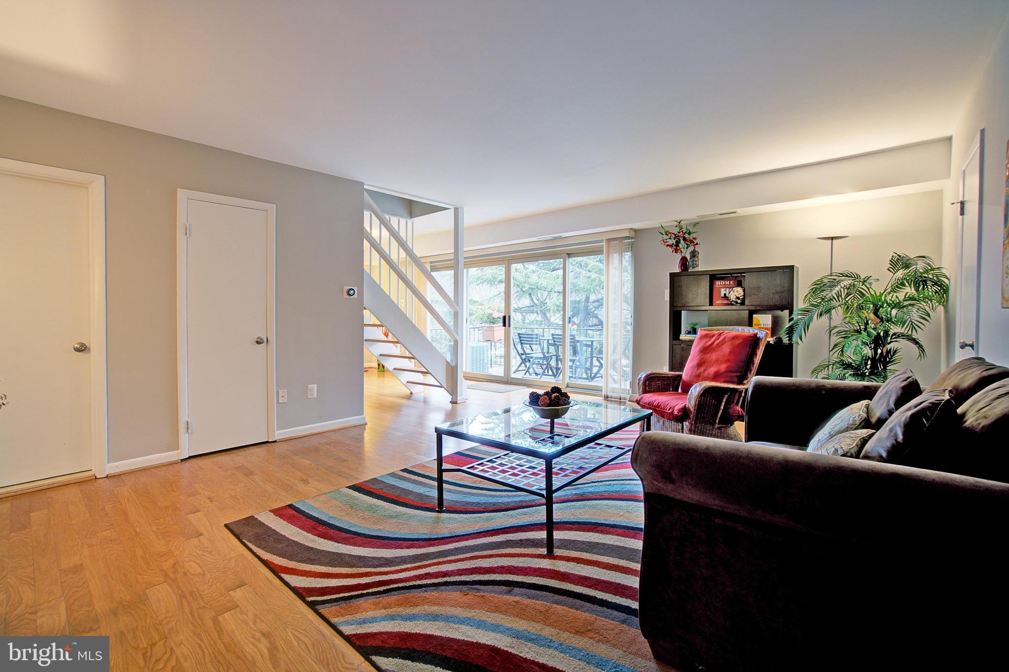 8706 Manchester Road, Unit 5 Silver Spring, MD 20901 - Photo 3 of 25 a living room with furniture and a potted plant