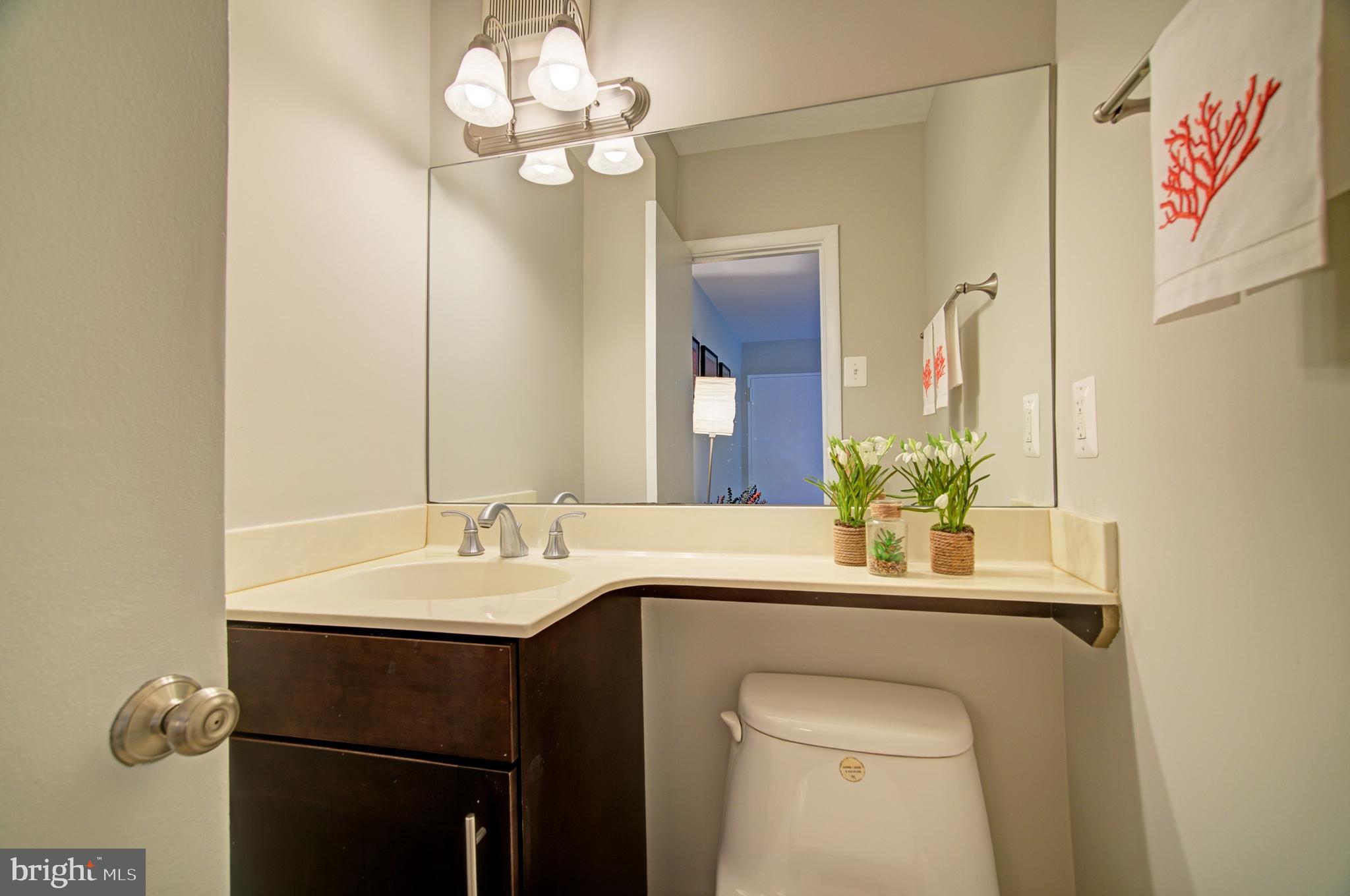 8706 Manchester Road, Unit 5 Silver Spring, MD 20901 - Photo 9 of 25 a bathroom with a sink a toilet and a mirror