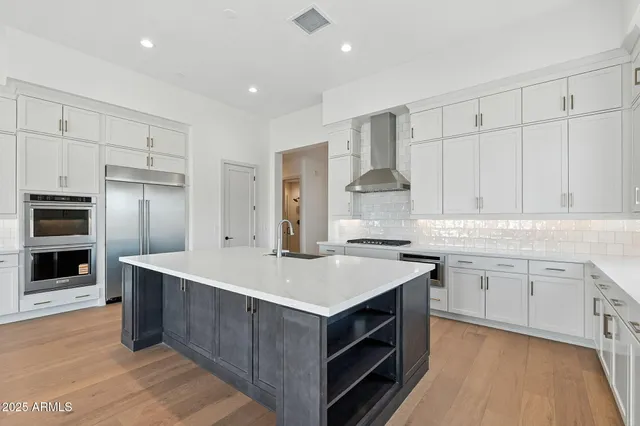 a kitchen with white cabinets and white appliances