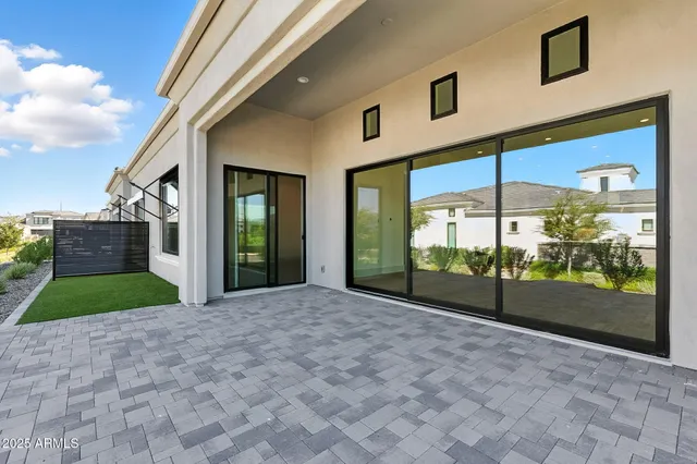 a view of a patio with couches potted plants and a table