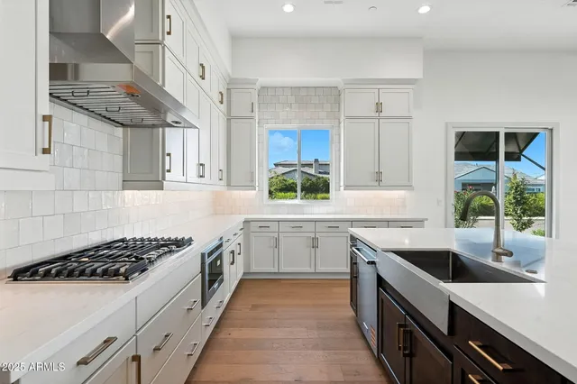 a kitchen with kitchen island a sink stove and window
