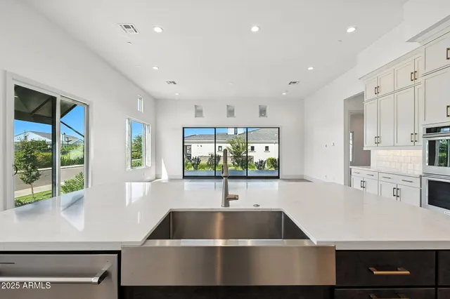 a kitchen with cabinets and stainless steel appliances