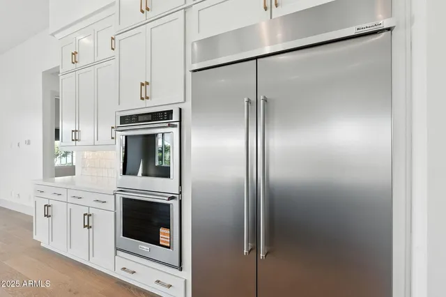 a living room with furniture a flat screen tv and a large window