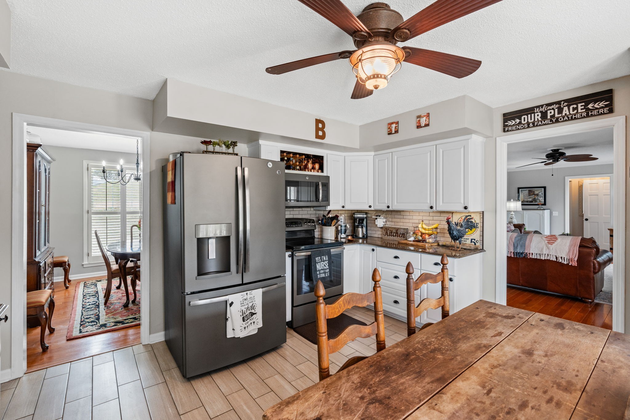 401 Bluegrass Court Lebanon, TN 37090 - Photo 17 of 51 a kitchen with stainless steel appliances granite countertop a refrigerator a stove a sink a dining table and chairs with wooden floor