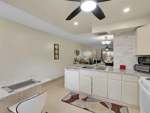 a kitchen with a sink and a stove top oven
