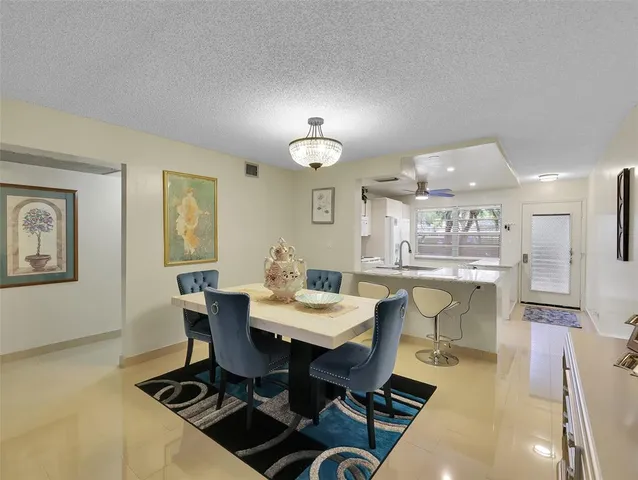 a view of a dining room with furniture and a chandelier