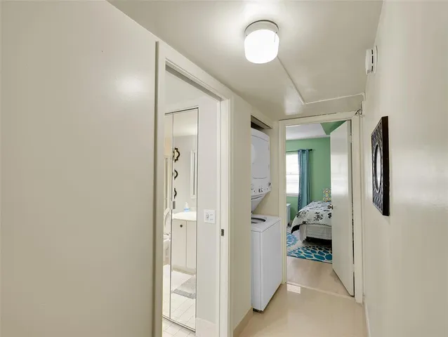 a view of a hallway with bathroom and wooden floor