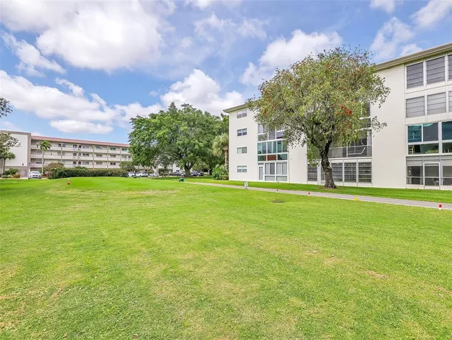 a view of a backyard with swimming pool