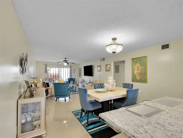 a living room with furniture a rug and a chandelier