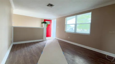 a view of an entryway with wooden floor