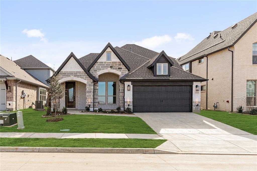 a front view of a house with a yard and garage