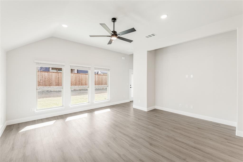 14505 Lovelace Street Pilot Point, TX 76258 - Photo 18 of 37 a view of an empty room with wooden floor and a window