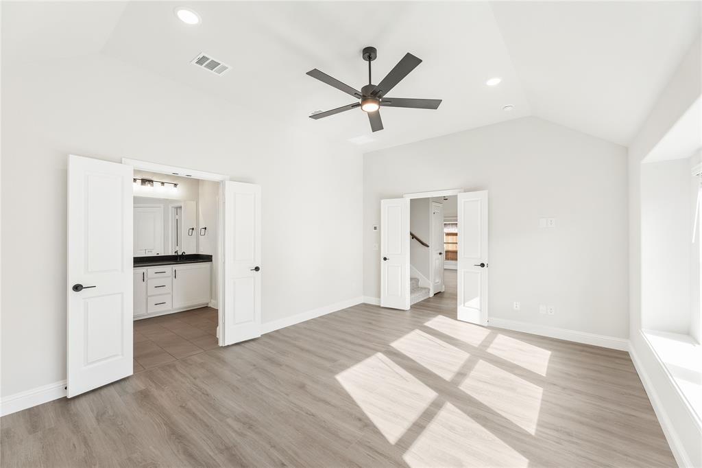 14505 Lovelace Street Pilot Point, TX 76258 - Photo 23 of 37 a view of a kitchen with wooden floor and a ceiling fan