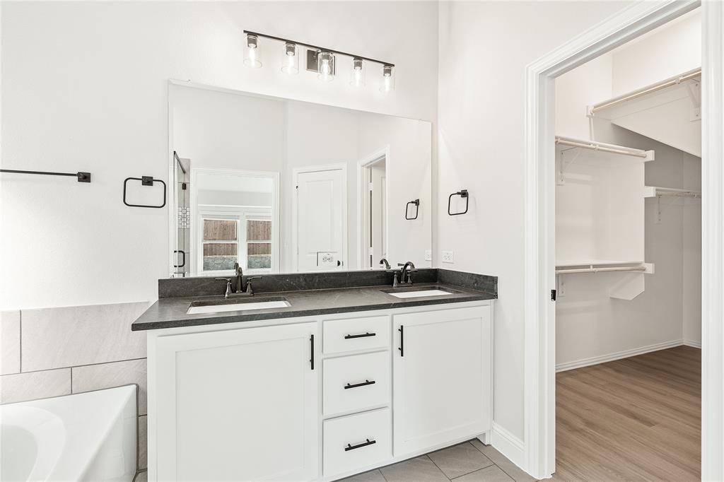 14505 Lovelace Street Pilot Point, TX 76258 - Photo 25 of 37 a bathroom with a granite countertop sink and a mirror