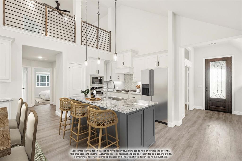 14505 Lovelace Street Pilot Point, TX 76258 - Photo 9 of 37 a view of kitchen island with stainless steel appliances kitchen island granite countertop dining room