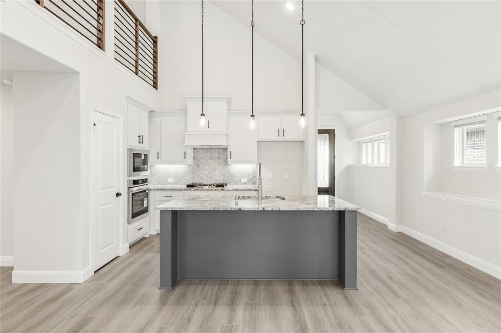 14505 Lovelace Street Pilot Point, TX 76258 - Photo 10 of 37 a kitchen with stainless steel appliances granite countertop a sink a stove and a refrigerator