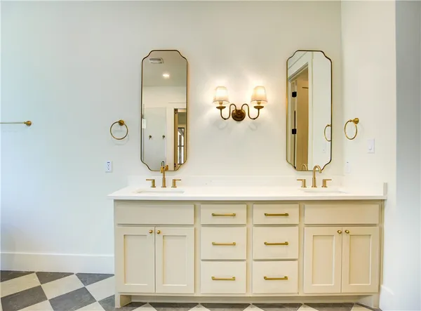 a bathroom with a double vanity sink mirror and