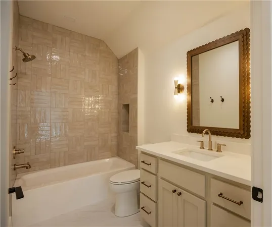 a bathroom with a bathtub shower sink mirror and toilet