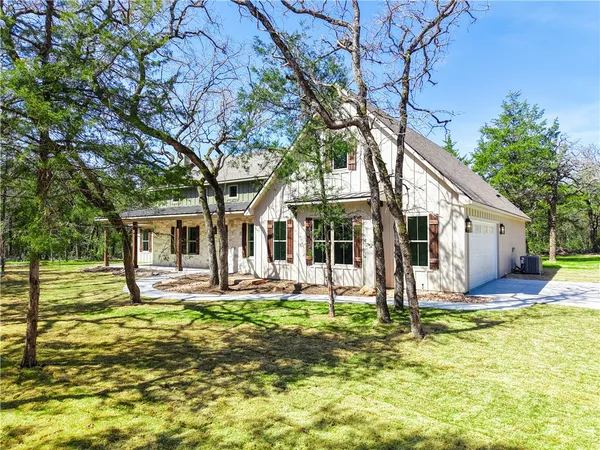 a front view of house with yard and green space