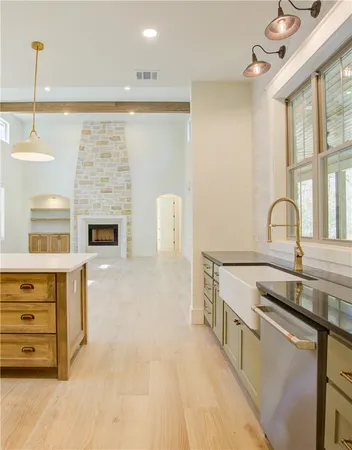 a kitchen with stainless steel appliances granite countertop a stove and a sink