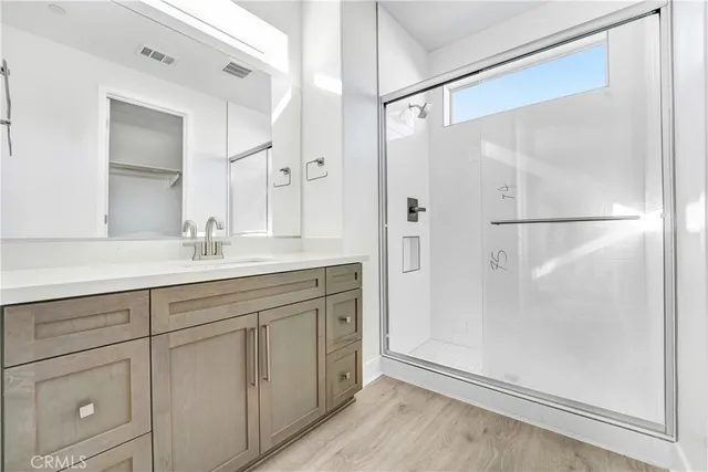 a bathroom with a double vanity sink mirror and shower