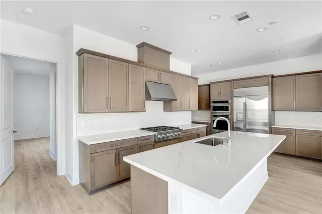 a kitchen with a sink a stove and cabinets