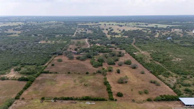 an aerial view of house with yard