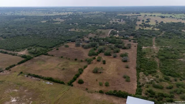 an aerial view of a house with a mountain