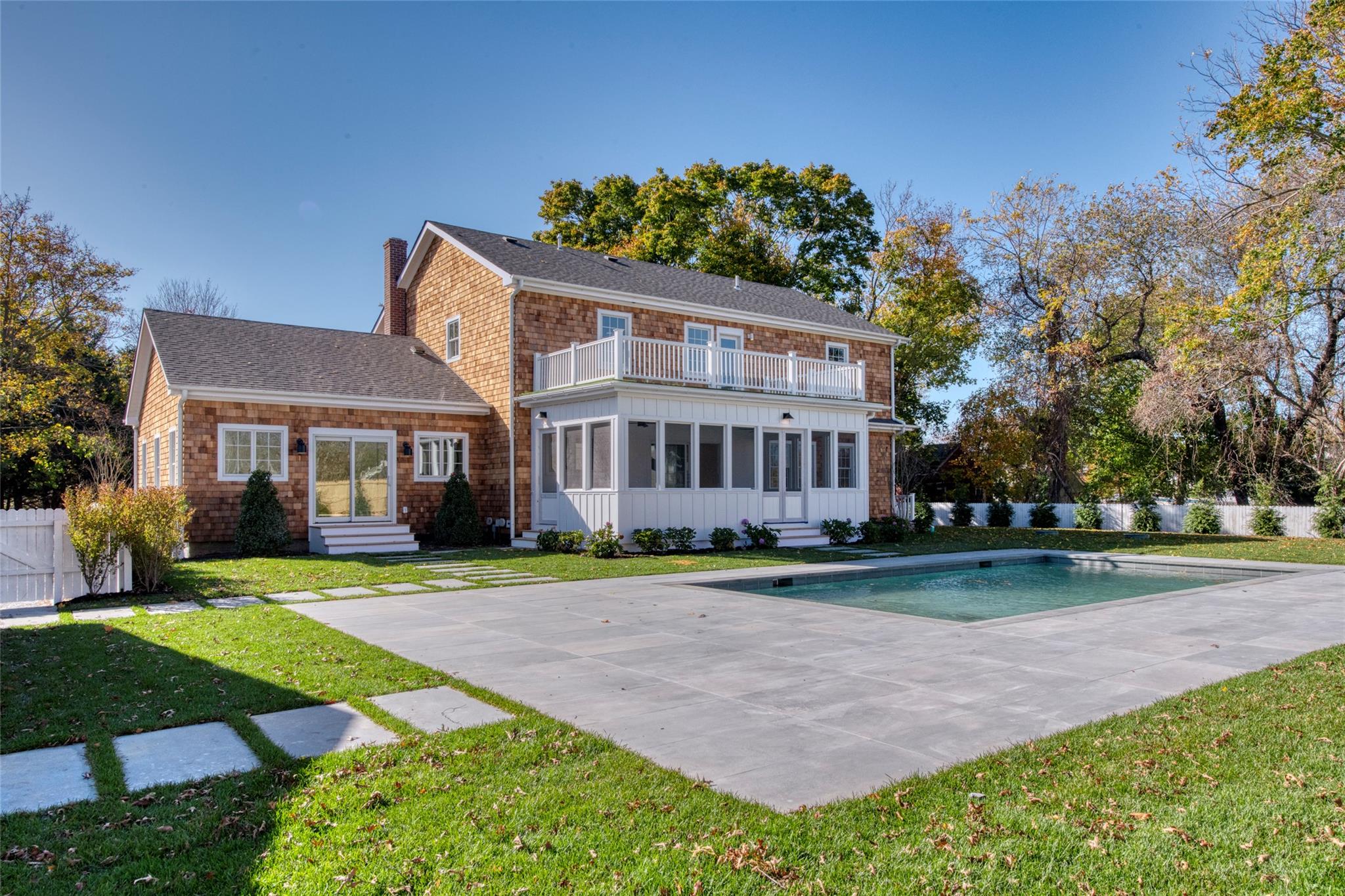 a front view of a house with a yard table and chairs