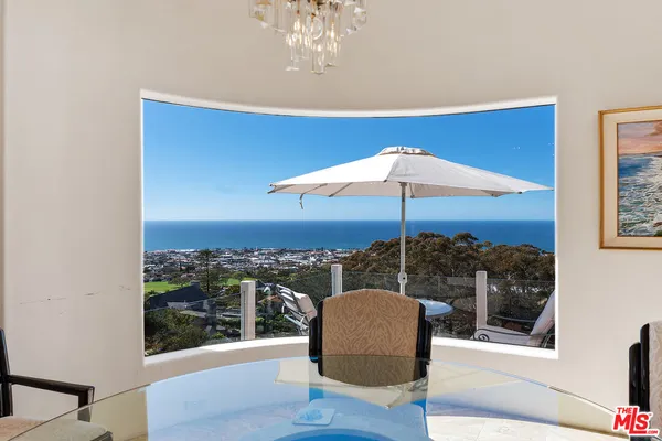 a kitchen with stainless steel appliances granite countertop a sink a stove and a wooden floors