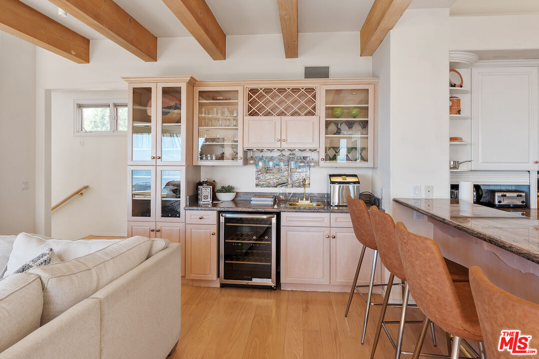 7350 Brodiaea Way La Jolla, CA 92037 - Photo 20 of 60 a kitchen with stainless steel appliances granite countertop a stove a sink dishwasher and a refrigerator with wooden floor