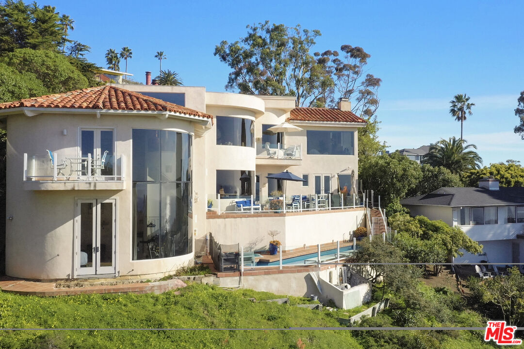 7350 Brodiaea Way La Jolla, CA 92037 - Photo 2 of 60 a front view of a house with a yard