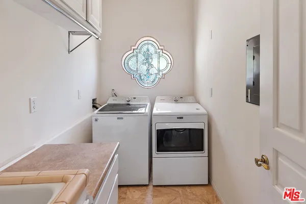 a large bathroom with a large tub sink and glass door