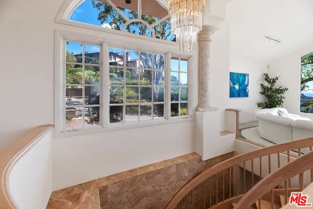 a large bathroom with a glass shower door and a sink