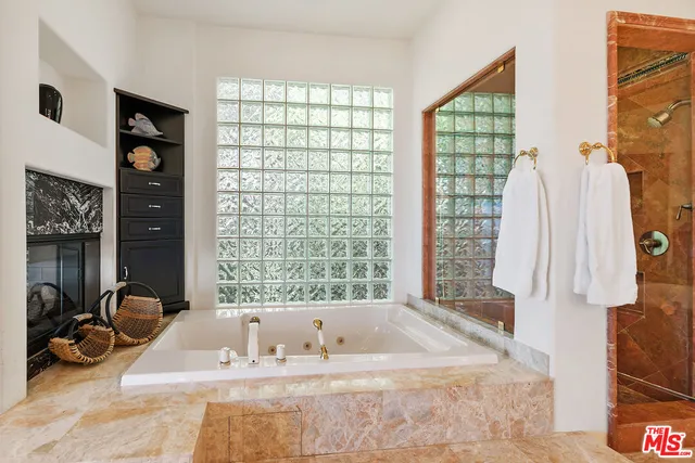 a dining room with furniture and a floor to ceiling window