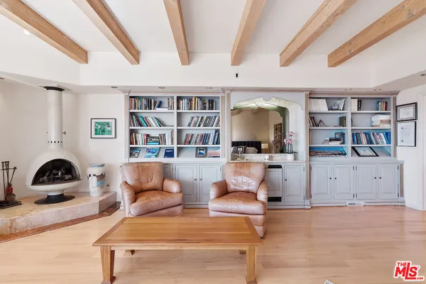 a living room with furniture a rug and a fireplace