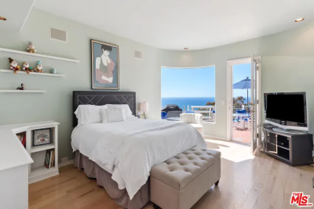 a bedroom with a bed a bookshelf and a bookshelf