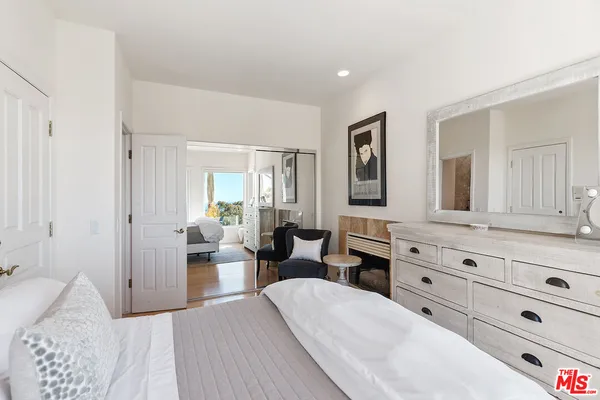 a view of a roof deck with couches and sky view