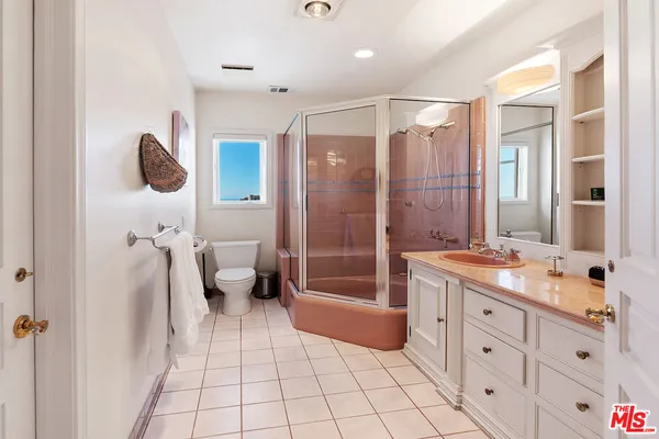 an aerial view of multiple houses with a yard