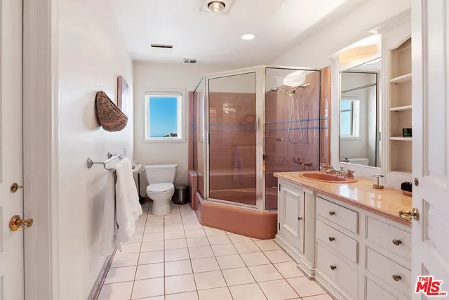 an aerial view of multiple houses with a yard