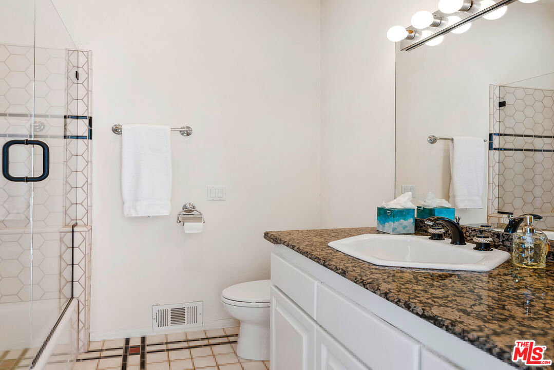 7350 Brodiaea Way La Jolla, CA 92037 - Photo 53 of 60 a bathroom with a granite countertop sink and a mirror