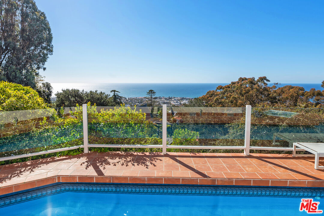 7350 Brodiaea Way La Jolla, CA 92037 - Photo 55 of 60 a view of a house with a swimming pool and a yard
