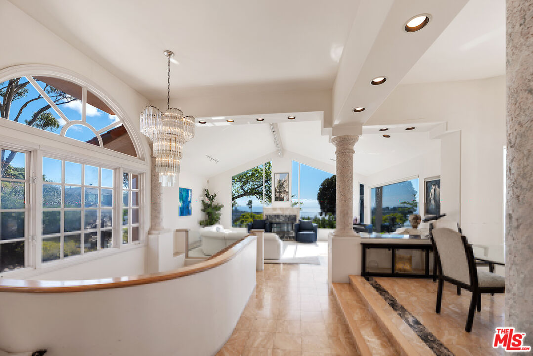 7350 Brodiaea Way La Jolla, CA 92037 - Photo 7 of 60 a living room with furniture and a chandelier