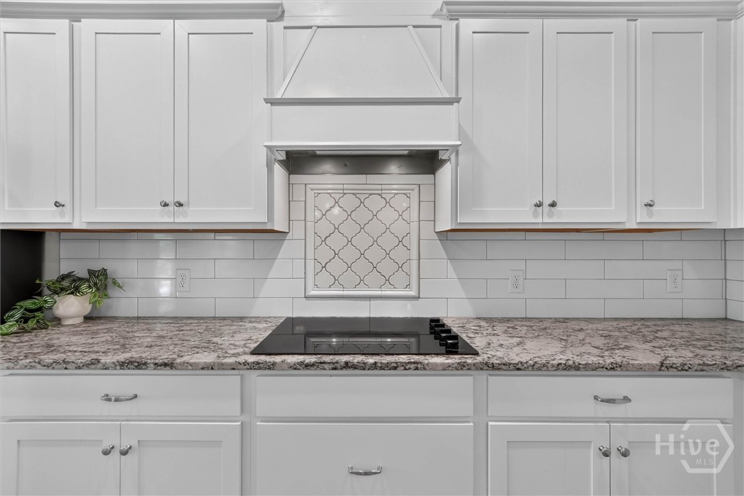 117 Treutlen Court Rincon, GA 31326 - Photo 10 of 45 Chef's kitchen with tile backsplash, custom vent hood, and granite countertops