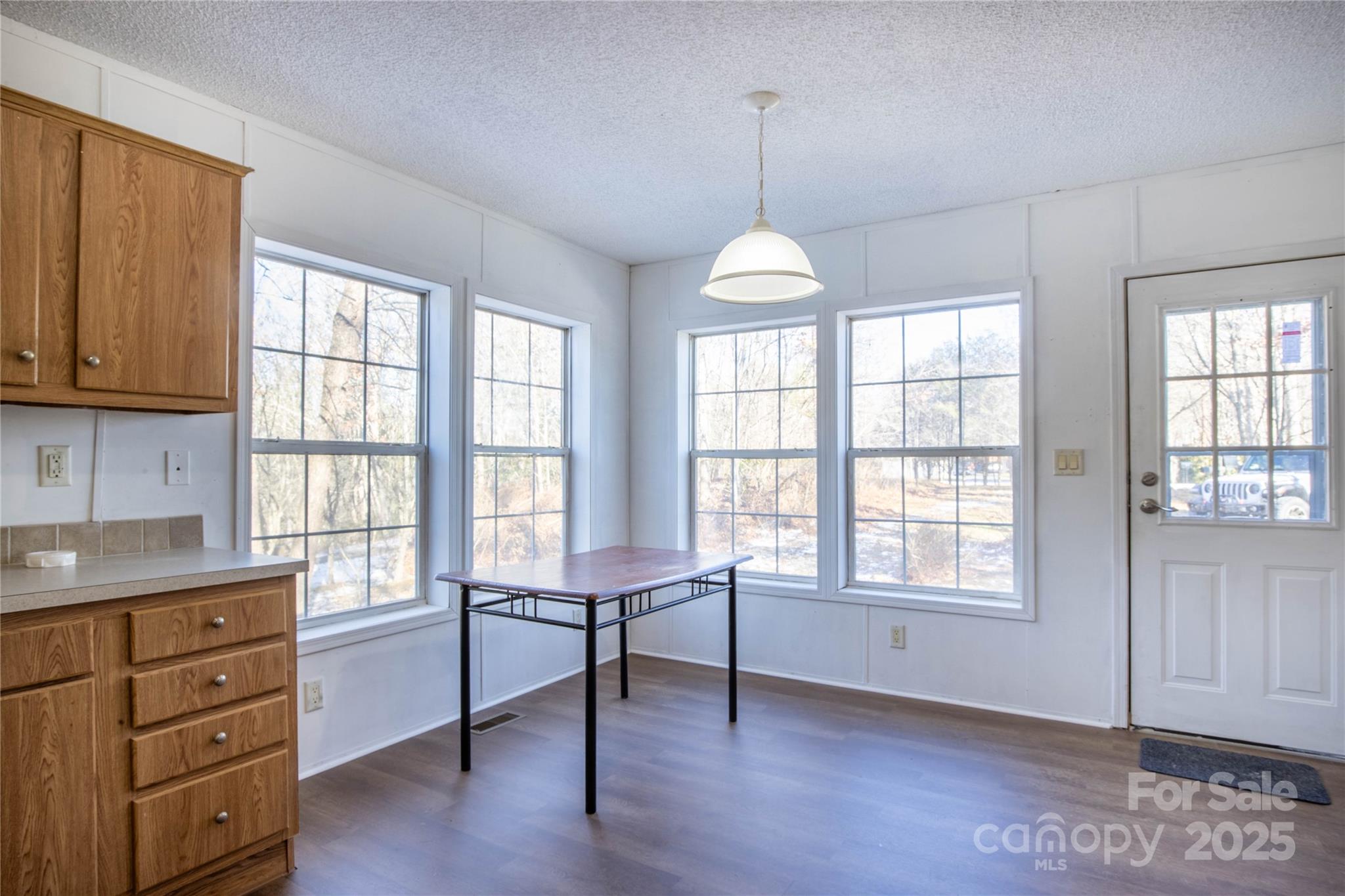 1960 Hanging Rock Road Spruce Pine, NC 28777 - Photo 28 of 47 a view of an empty room with a window and wooden floor