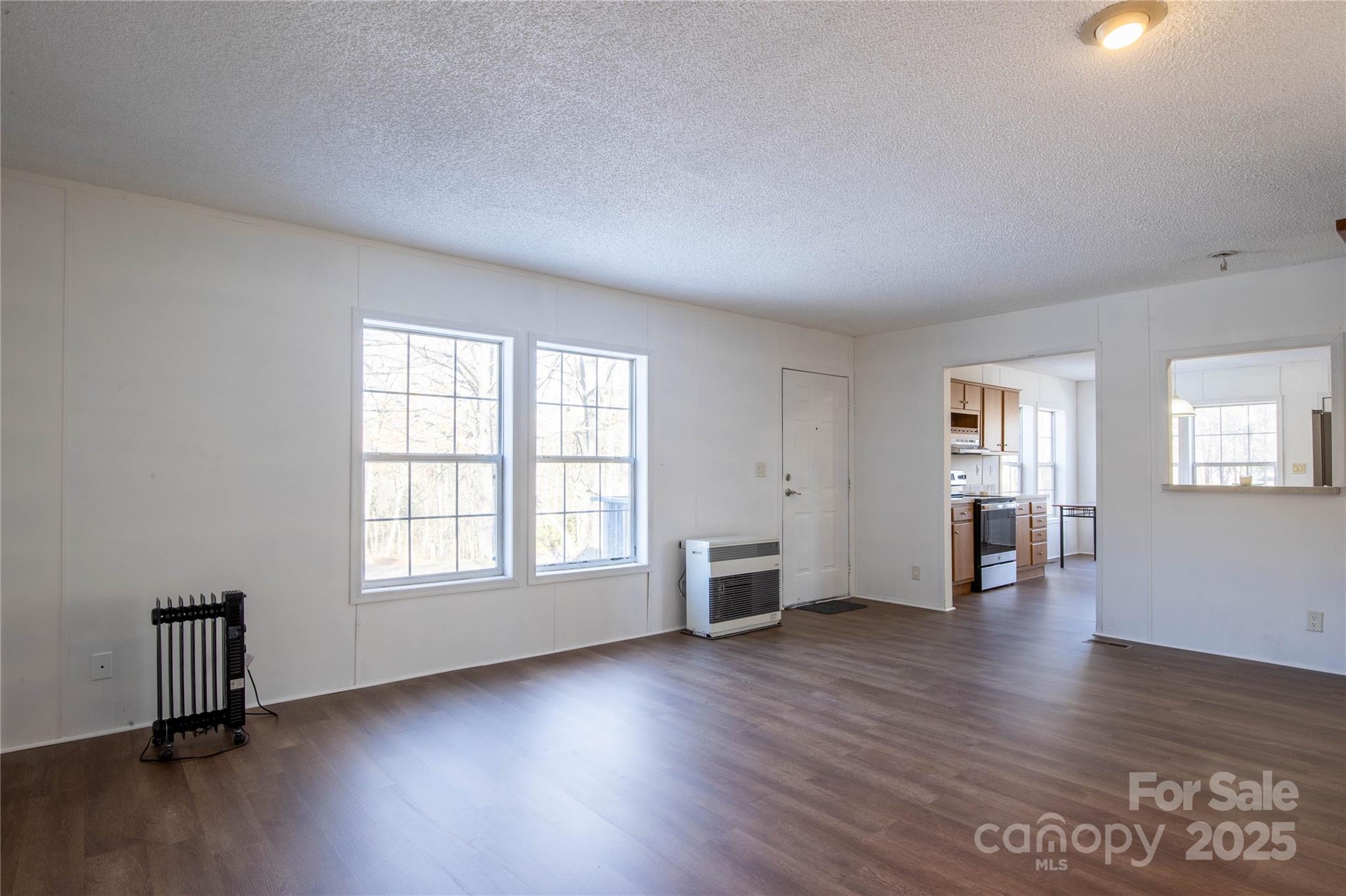 1960 Hanging Rock Road Spruce Pine, NC 28777 - Photo 31 of 47 an empty room with wooden floor and windows